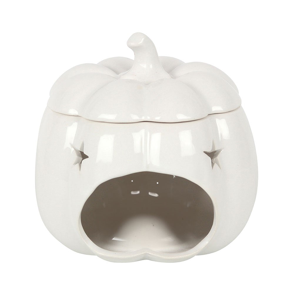 White ceramic pumpkin oil burner creating a warm cosy autumn atmosphere with neutral seasonal décor