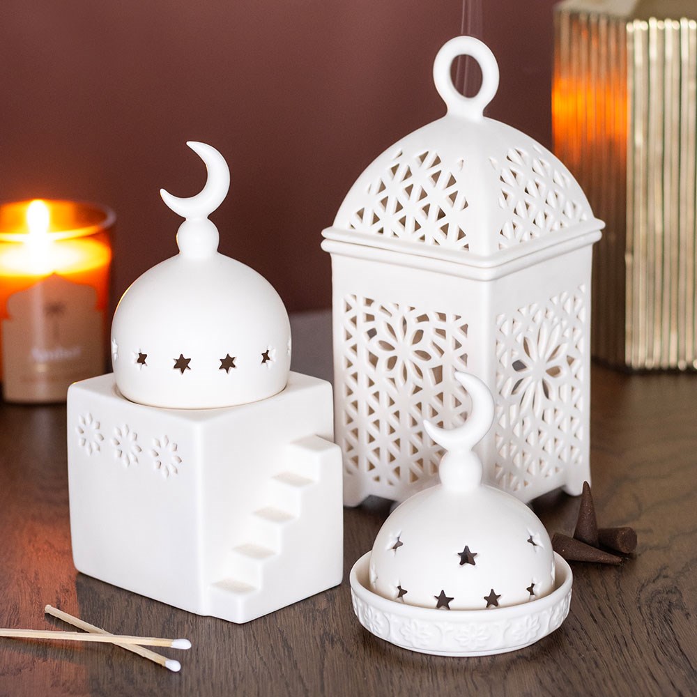 Decorative lantern fragrance burner styled in a warm cosy home with incense and home fragrance accessories
