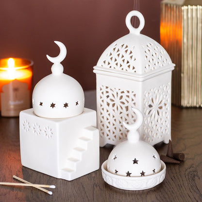 Decorative lantern fragrance burner styled in a warm cosy home with incense and home fragrance accessories