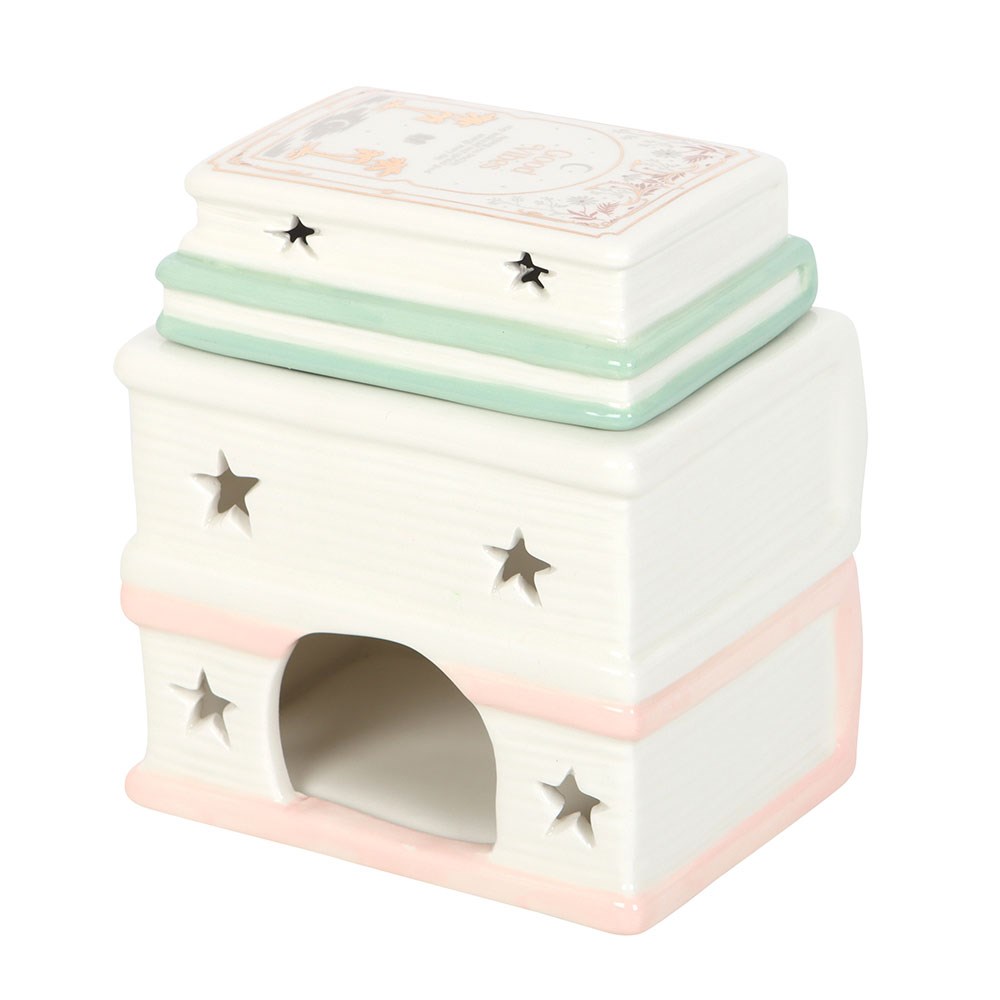 Ceramic book stack oil burner and wax warmer displayed as bookish home décor