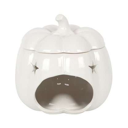 White ceramic pumpkin oil burner creating a warm cosy autumn atmosphere with neutral seasonal décor