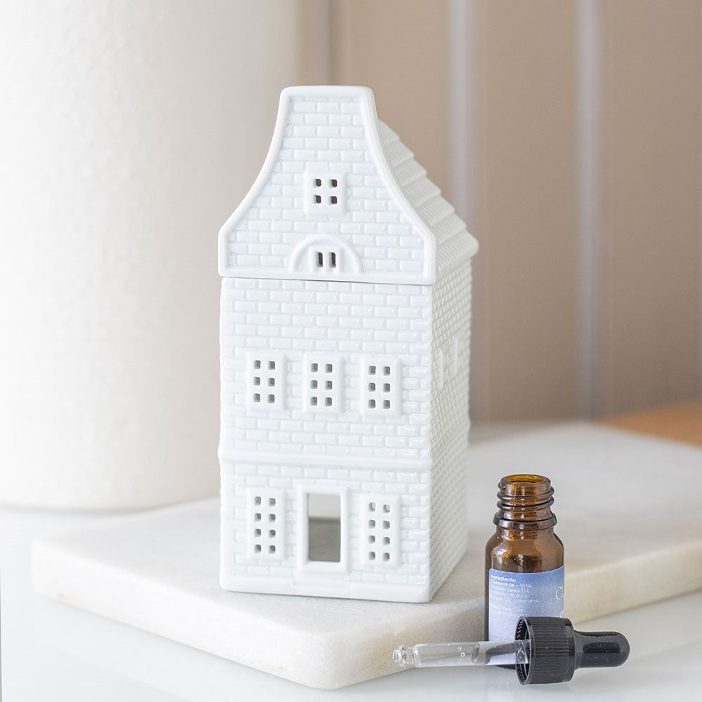 White ceramic house wax warmer styled with Especially Scent wax melts for a cosy evening at home