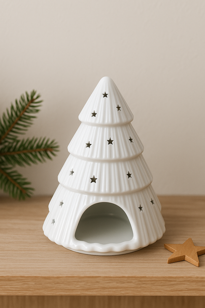 White ceramic Christmas tree wax melt burner with star cut-outs on a minimalist Christmas background.