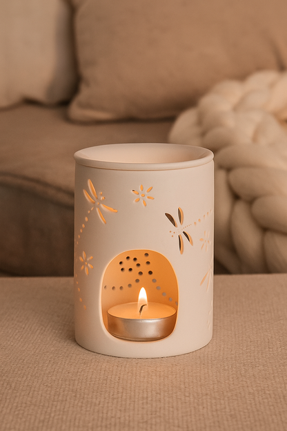 white ceramic dragonfly cut-out wax melt burner on wooden surface